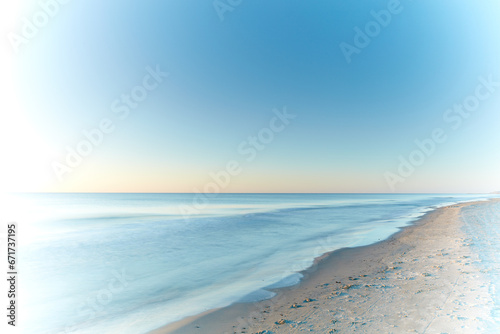 Copyspace seascape and landscape of a pretty sunset on the westcoast of Jutland in Loekken, Denmark. Beautiful view on an empty beach at dusk. Sun rising over the ocean and sea in the morning