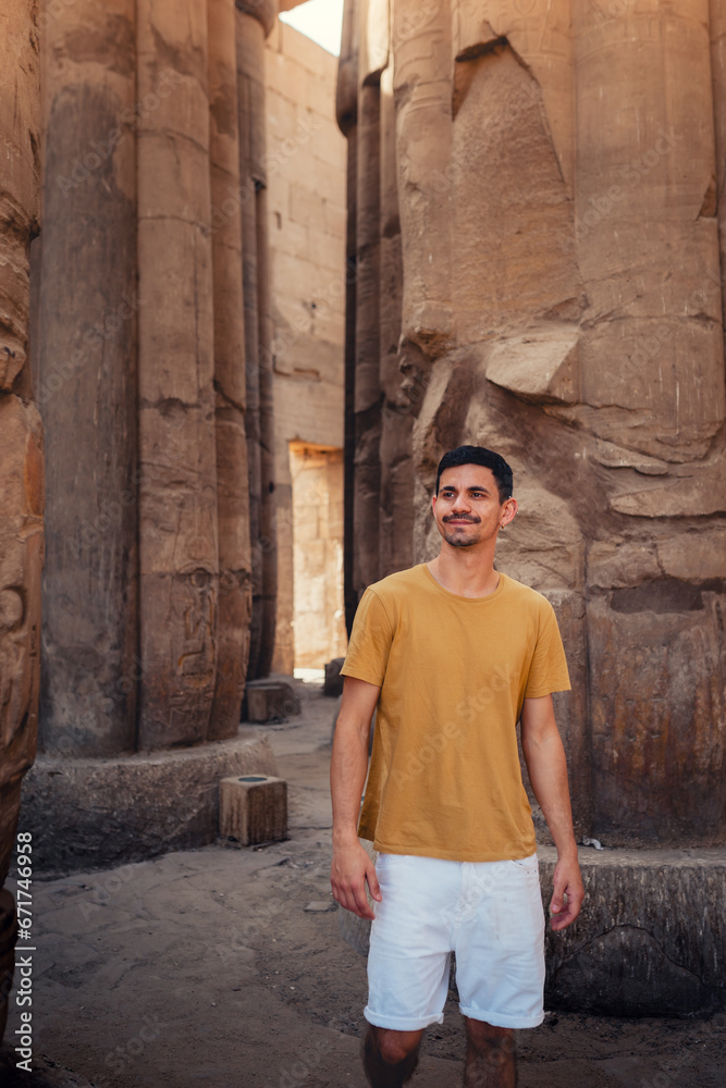 young male traveler visits Luxor temple in Luxor, Egypt