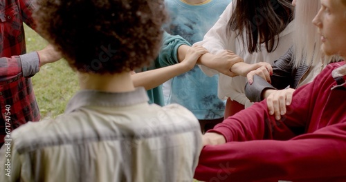 People during group somatic therapy to self-discovery, emotional healing, personal growth, connection between body and mind. Ukranian refuges ptsd trauma psychotherapy People in circle joined hands.  photo