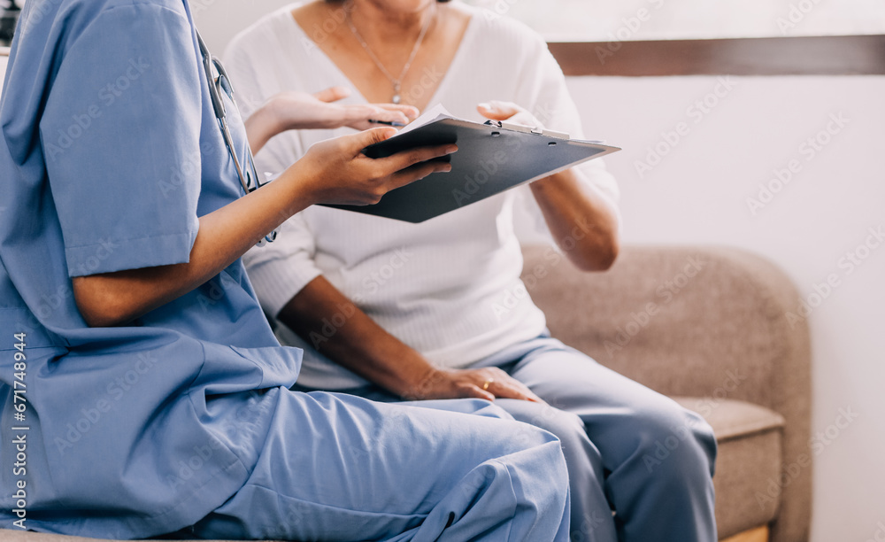 Doctor showing medical card to patient at table in clinic, closeup