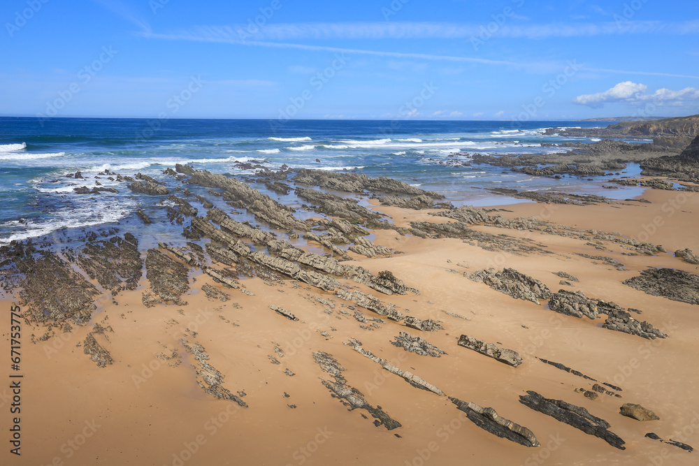 Beautiful Almograve beach with black basalt rocks in Portugal Beautiful Almograve beach with black basalt rocks in Portugal