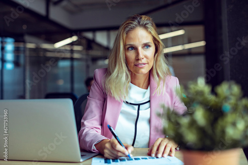 Focused professional working diligently in a contemporary office setting photo