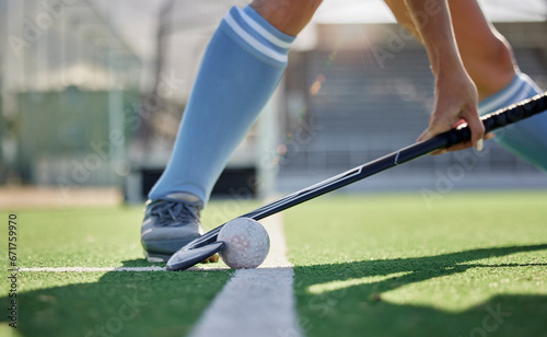 Hockey, sports and ball with a stick in the hands of a woman athlete on a pitch during a competitive game. Fitness, exercise and sport with a female hockey player playing a match on a grass court photo