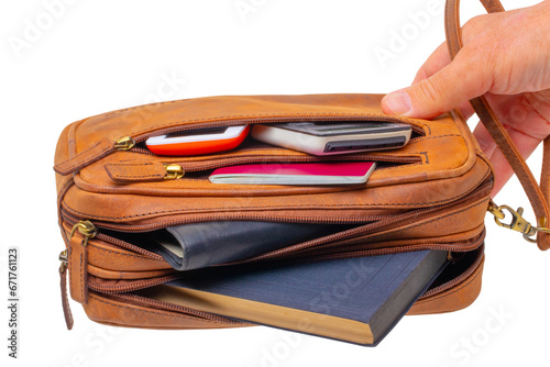 Leather handbag isolated. One hand holds a spacious brown luxury leather wrist bag. Fashionable businessman's bag or briefcase. Clipping Path. © Olga