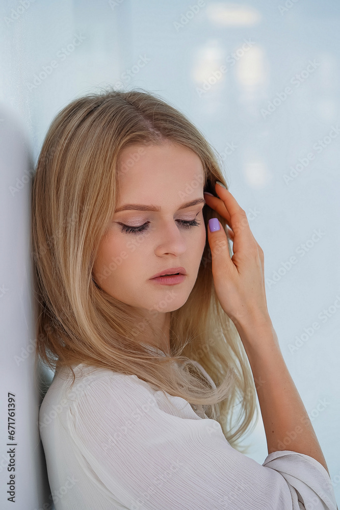 Portrait of attractive smiling young blonde woman with perfect smile. Pretty healthy young female with light natural face makeup inside white interior. Portrait of attractive smiling young blonde woman with perfect smile. Pretty healthy young female with light natural face makeup inside white interior.