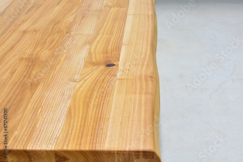 Wooden dinner table surface. Natural wood furniture close view