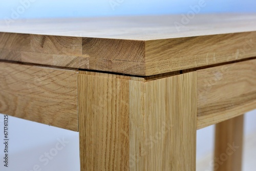 Wooden dinner table surface. Natural wood furniture close view