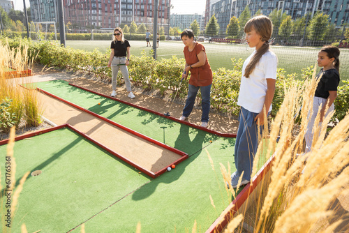 Kids playing golf inside playground artificial grass activity game for children 