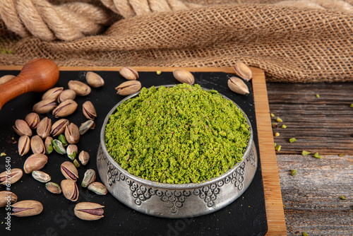 Pistachio powder. Ground  milled  crushed or granulated pistachio pile from top view.
