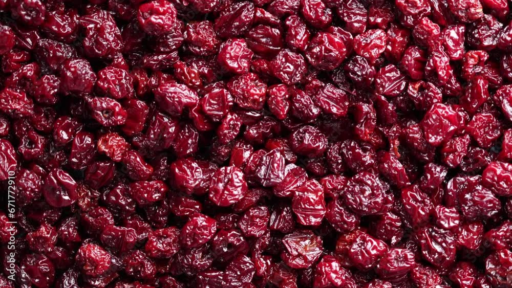 Dry red pitted cherries in the background, close up, top view, rotating. A way to preserve vitamins. Vegetarian meal, healthy and useful Dry red pitted cherries in the background, close up, top view, rotating. A way to preserve vitamins. Vegetarian meal, healthy and useful