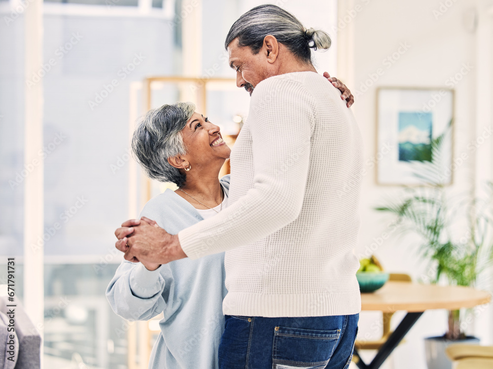 Obraz premium Senior couple, hug and holding hands in dance for love, care or bonding together in living room at home. Elderly man and woman enjoying quality time, weekend or holiday celebration for anniversary