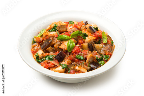 Eggplant stew with tomatoes and spinach in a salad isolated on white background.