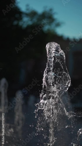 city fountain with splashing jet of clean transparent water, slow motion photo