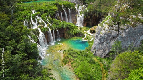 Fototapeta Naklejka Na Ścianę i Meble -  Plitvice waterfalls in mountain landscape of Croatia. Blue and green can be seen in the cascades. Water streams flow into a lake.