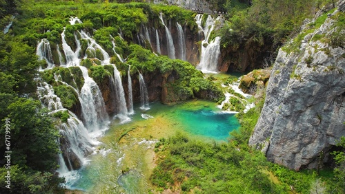 Summer forest and mountain landscape with streams of water and waterfalls. Cascades flow among lush greenery.