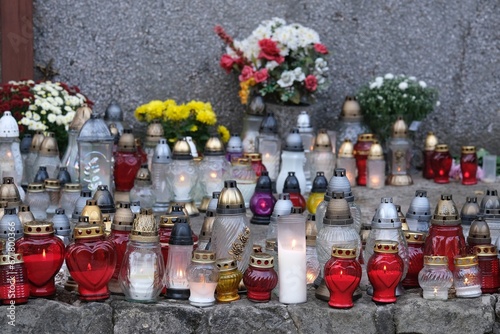 A lot of colorful lit candles standing at the memorial site