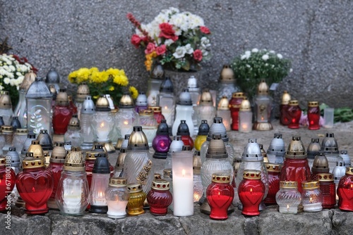 A lot of colorful lit candles standing at the memorial site