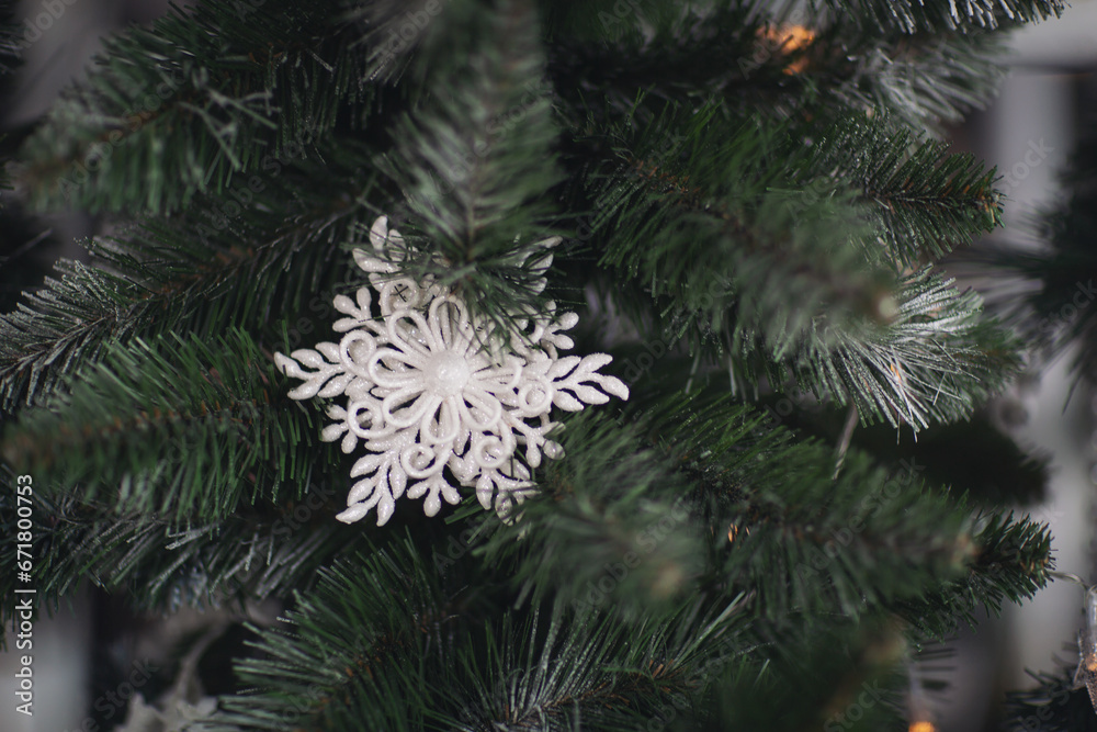 Christmas decorations, background blur. Christmas decorations on the holiday tree. Many balls garland glowing lamps on the branches. Christmas and New Year ornament. Christmas beautiful lights bokeh.