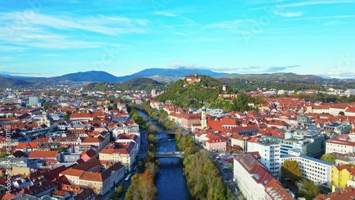 Aerial flight over the roofs of the historic city centre of Graz in Austria on a beautiful autumn evening	
