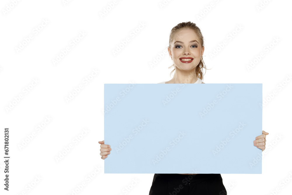 Banner of young happy blonde woman feeling happiness and holding blue Empty white canvas frame for text or advertising isolated on white background Banner of young happy blonde woman feeling happiness and holding blue Empty white canvas frame for text or advertising isolated on white background