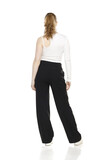 back view of young blond woman in trousers and white blouses posing on white background