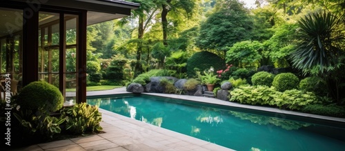 Luxury villa with small garden and tree surrounded swimming pool photo