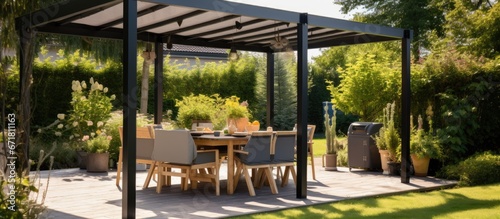 Stylish outdoor pergola with landscaping awning and grill photo