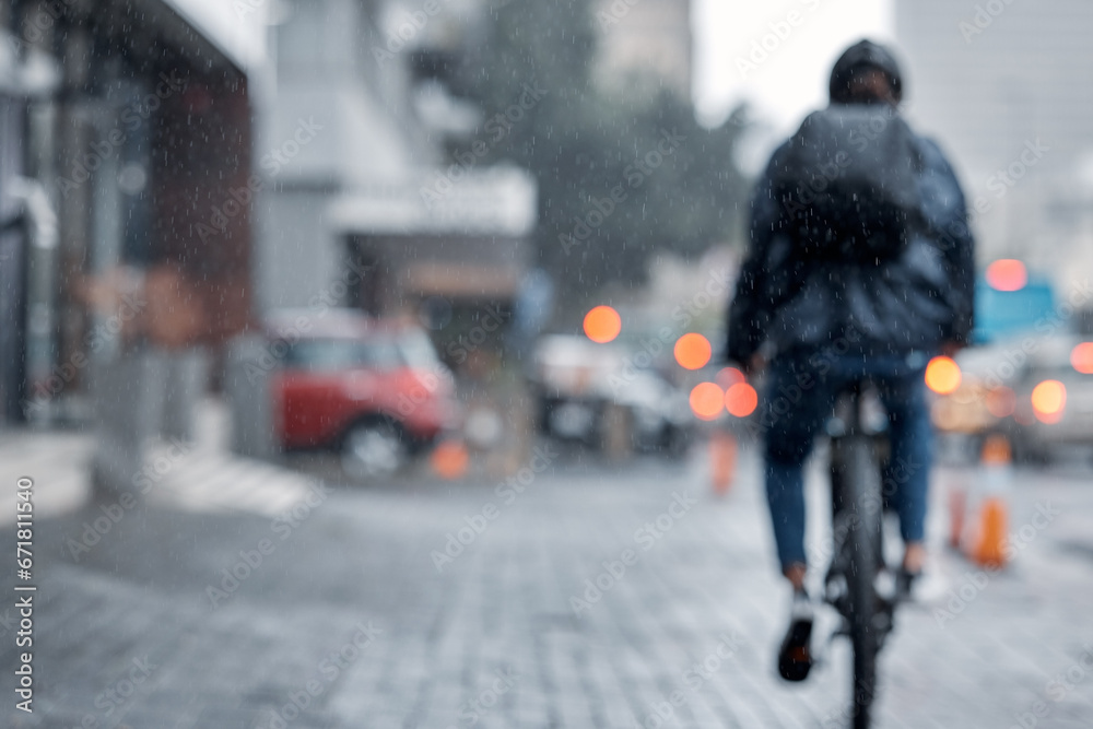 Cyclist, bicycle and delivery in the city on rainy day or cold weather in an urban town on mockup. Biker riding in the rain with cargo, transport or deliver service in a urban town street for courier - obrazy, fototapety, plakaty 