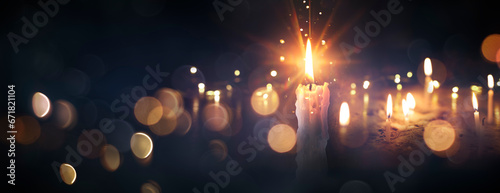 Flames Of Candles In The Dark - Memory Day And Condolence Card With Defocused Lights And Flare Effect photo