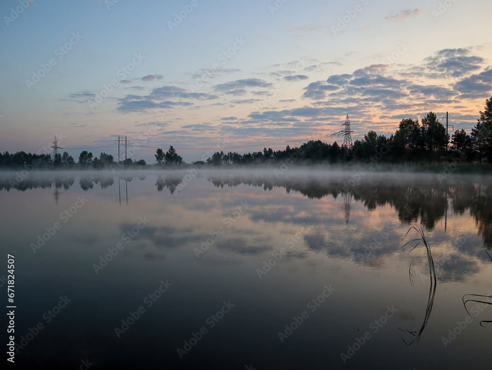 Fog over the lake in the morning. Sunrise.