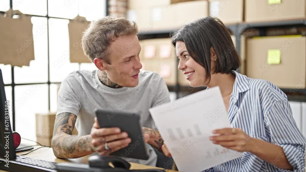 Two ecommerce business workers using touchpad reading document at office Two ecommerce business workers using touchpad reading document at office