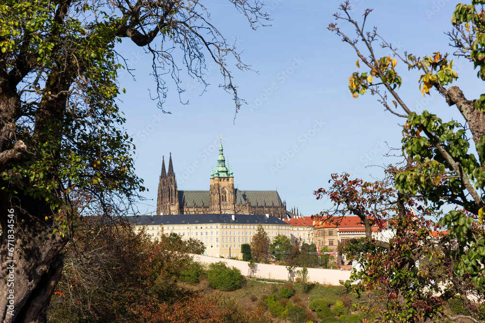 Autumn Prague City with gothic Castle, colorful Nature and Trees with blue Sky from the Hill Petrin, Czech Republic