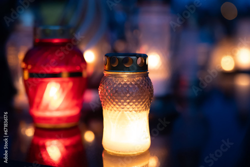 Candle light in the cemetery at night. Selective focus.All saint's day. Lanterns in the cemetery at night.Lantern on the background of burning candles in the night.