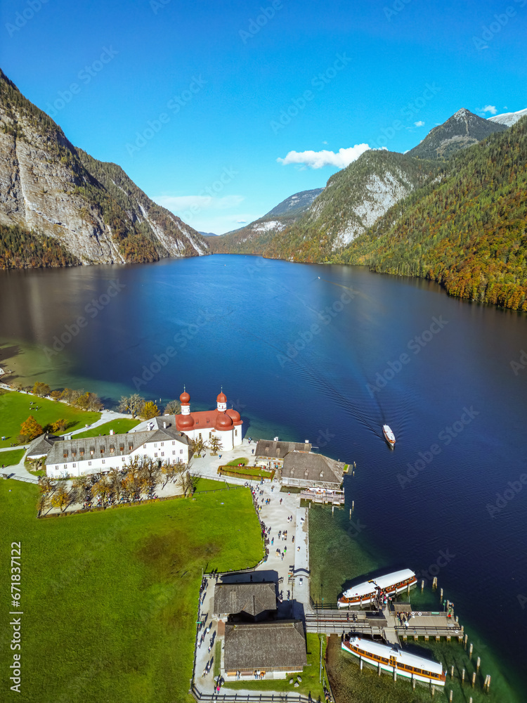 aerial panoramic view of lake konigssee with sankt bartholomae pilgrimage church and watzmann mountain, berchtesgadener land, bavaria, germany.