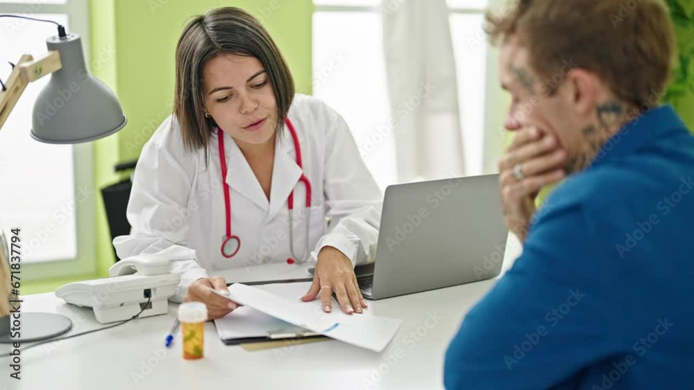 Doctor showing medical report to patient at the clinic Doctor showing medical report to patient at the clinic