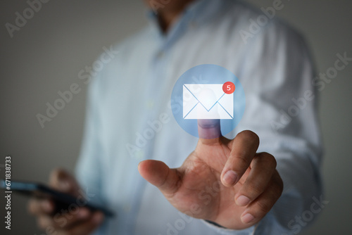 Email marketing concept. Business people hand touch new mail notification icon. For communication and digital campaign information, contact us by newsletter. Inbox receives electronic message alerts.