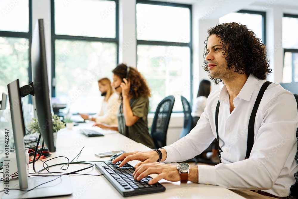 Fototapeta premium Man working with computer on a community coworking