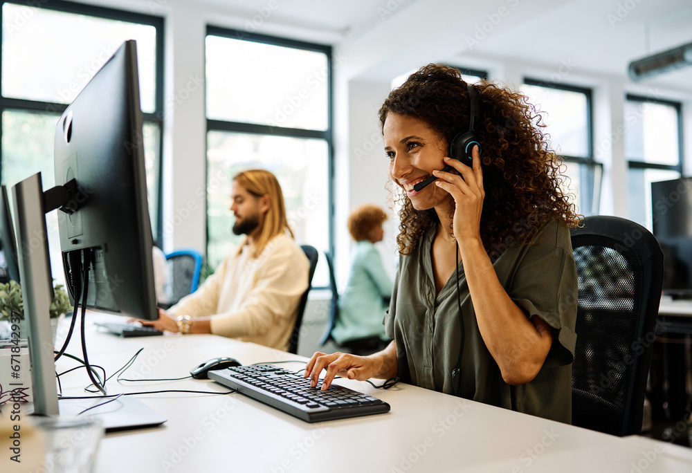 Woman working with computer in a coworking call center Woman working with computer in a coworking call center