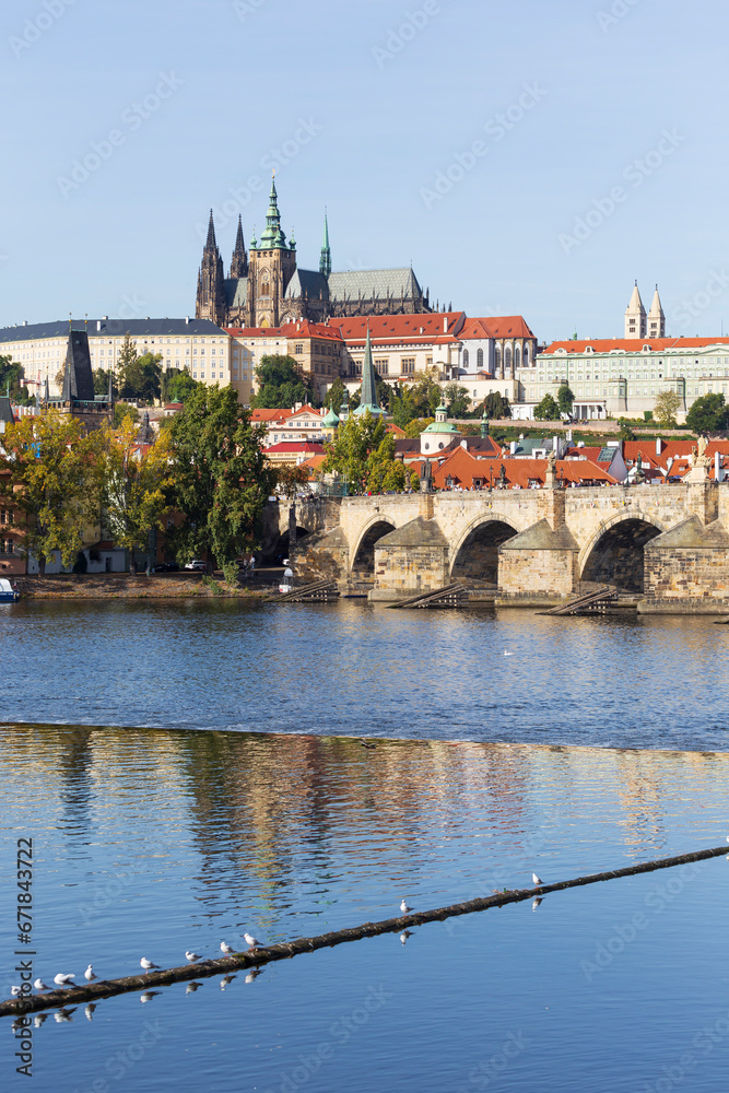 Obraz premium Autumn colorful Prague Lesser Town with gothic Castle above River Vltava in the sunny Day, Czech Republic