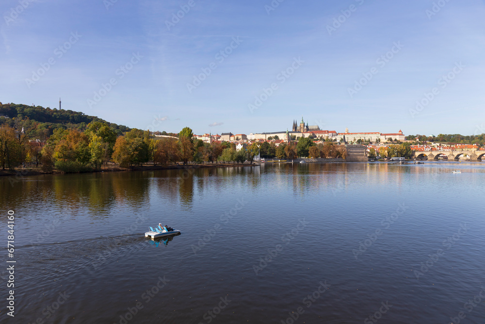 Obraz premium Autumn colorful Prague Lesser Town with gothic Castle above River Vltava in the sunny Day, Czech Republic