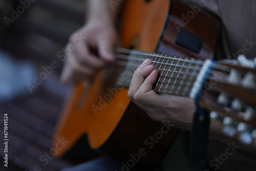 the person who plays a classical guitar. tomorrow's detail that uses a musical instrument. classical guitar.
