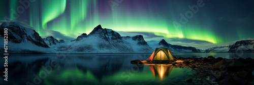 A camping tent glowing under the northern lights, Aurora Borealis. Travel and adventure photo
