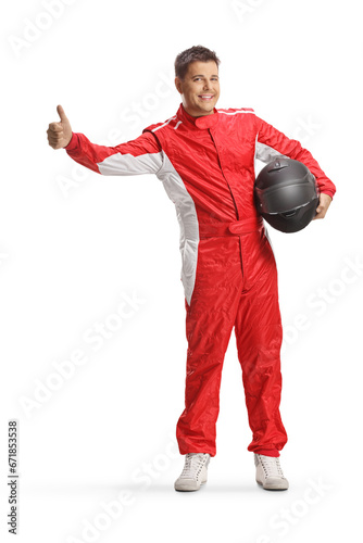 Racer in a red suit holding a helmet and hitchhiking