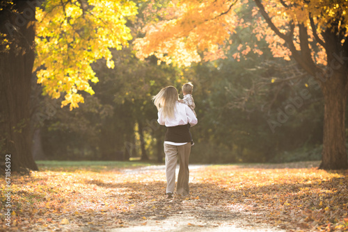 Mothers day, love family.  Family on autumn walk in nature outdoors. Mother and child with hugging tenderness © Maria