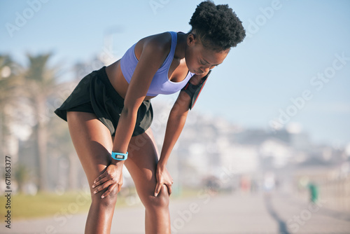 Black woman, tired and breathing for sports training, exercise break or workout challenge in city. Young female athlete, rest and breath from fitness, outdoor running and fatigue of cardio marathon photo