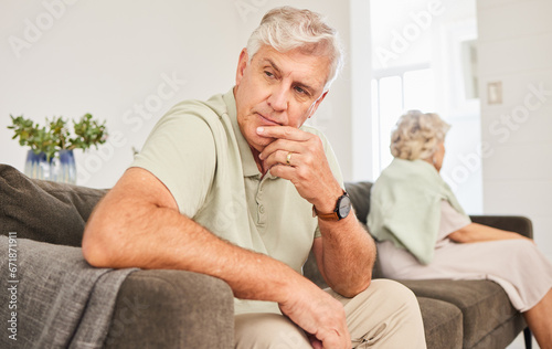 Senior man, fight and thinking of divorce, breakup and stress of sad separation on sofa at home. Frustrated couple on couch in conflict, crisis and problem of drama, bad marriage or emotional anxiety