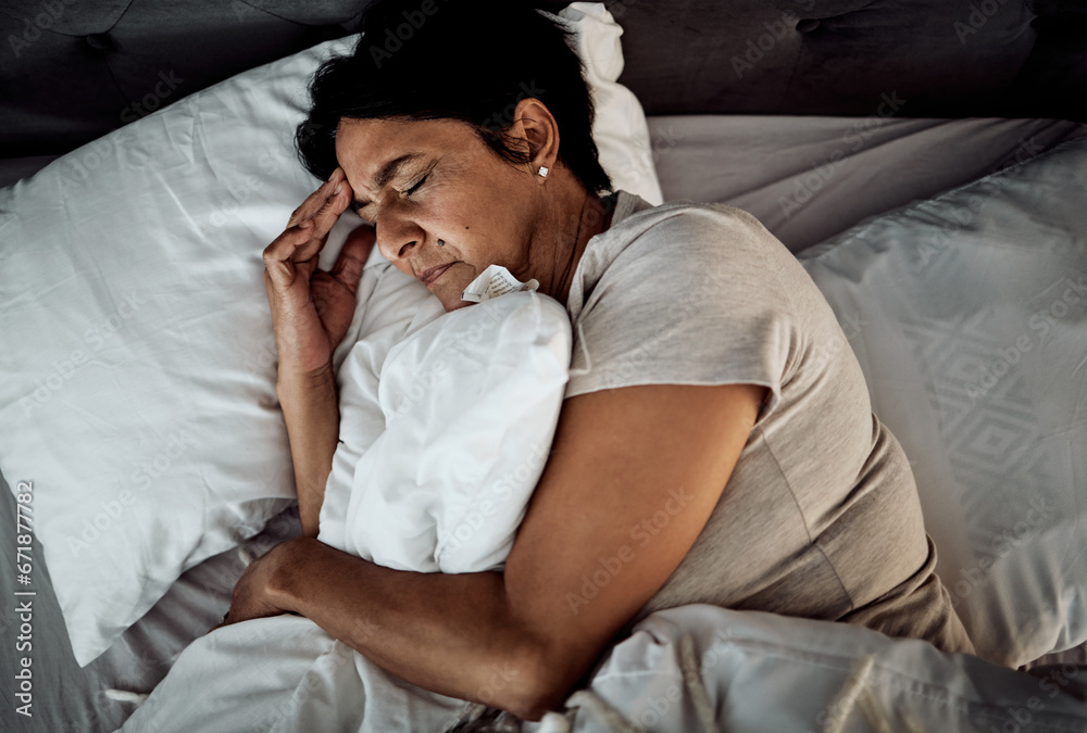 © David Lahoud/peopleimages.com - Headache, stress and senior woman in bed from above with depression, insomnia or menopause. Anxiety, migraine and top view of old lady with vertigo, trauma or mental health, problem or bedroom crisis