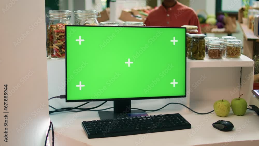 Vidéo Stock Seller at register uses greenscreen on computer, showing ...