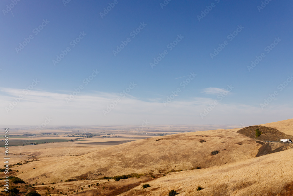 Beautiful autumn landscape with meadows and a road from a bird's eye view. Nature in Oregon in fall. Panorama. Pendleton, Oregon, USA