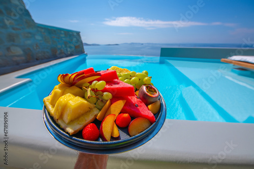 Infinity swimming pool in the villa with fruit plate, Mykonos, Greece